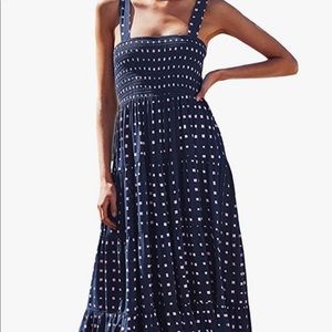 Great summer sundress! Navy blue polka dot with stretch bust and tiered shirt.